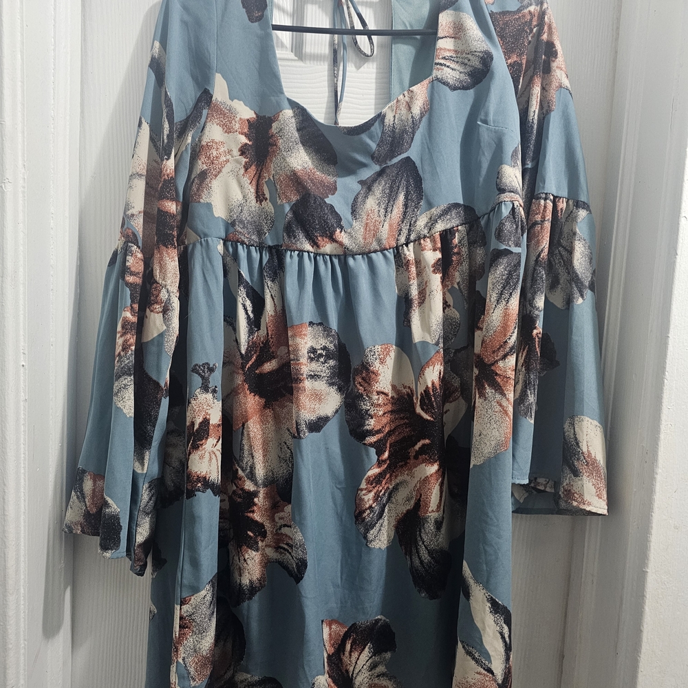 ￼

This is an Altar'd State Blue Floral Square Neck Tie Back Mini Dress